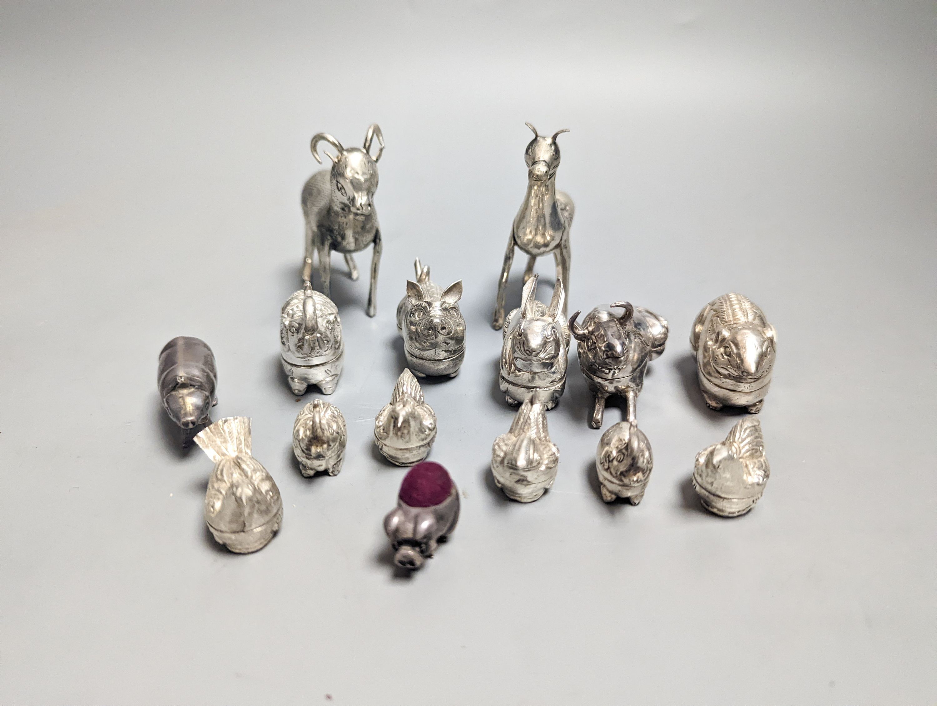 A modern 925 mounted pig pin cushion, 24mm, a similar pig vesta case, four small 925 'hen' boxes and nine base metal animal boxes etc.